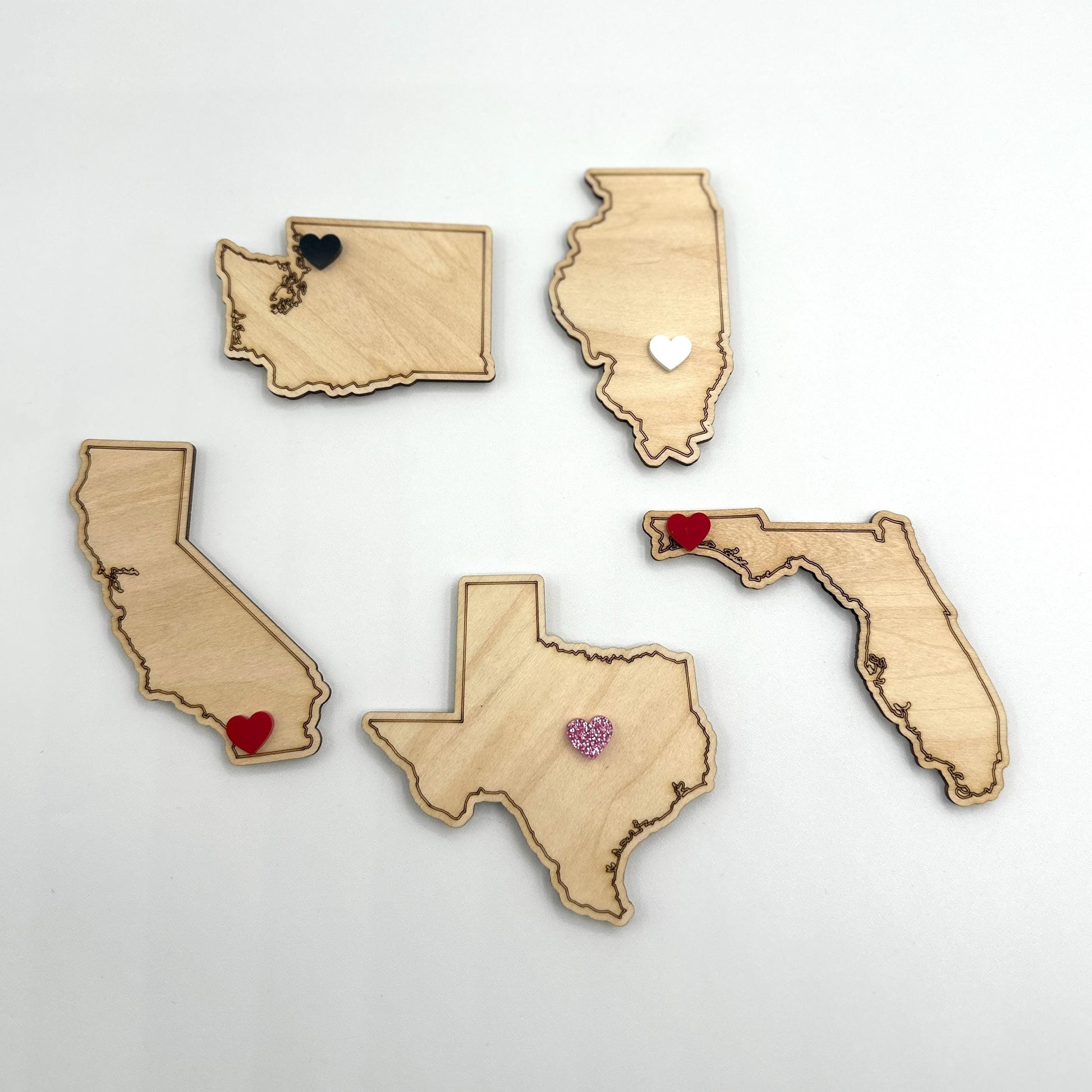 State Wooden Magnets | 50 States Wooden Magnet| Save The Date Magnet| Wedding Favor| Acrylic Magnet | Personalized Wooden Magnet| Home State
May include: Five wooden state outlines with red, pink, black, and white hearts placed on them. The states are Washington, Illinois, California, Texas, and Florida.