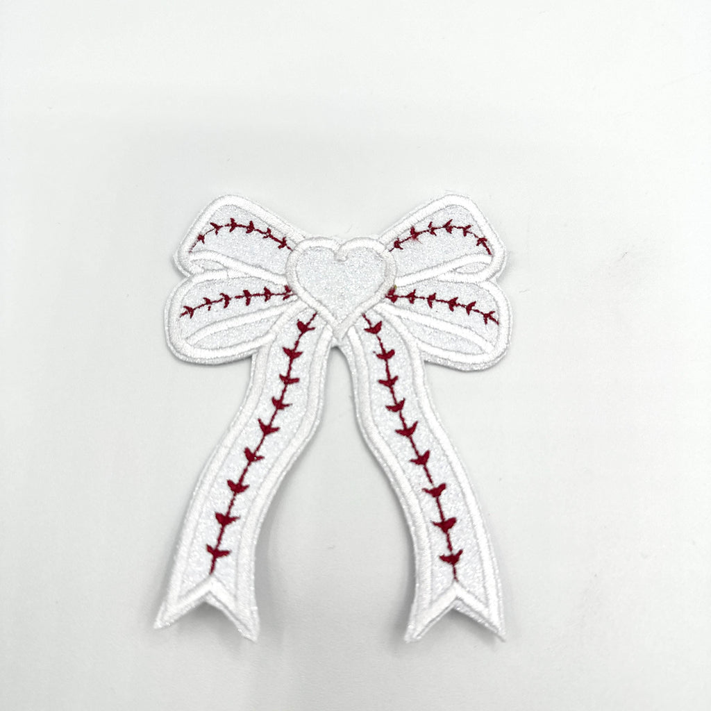 Baseball Custom Embroidered Side Bow Patch| Iron On| Side Bow Applique| Glitter Side Bow|  Embroidered Side Bow| Coquette Side Bow| Patches
May include: A white bow with red stitching in the shape of a baseball stitch. The bow has a white heart in the center.