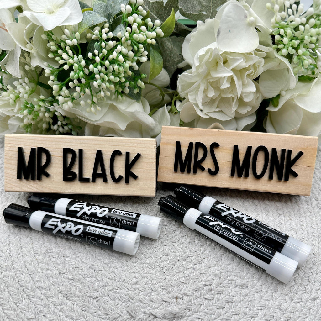 Custom Eraser With Expo Markers For Teachers| Teacher Eraser| Whiteboard Eraser| Gift For Teachers | Back To School | Teacher Appreciation

May include: Two wooden blocks with the text &#39;MR BLACK&#39; and &#39;MRS MONK&#39; written in black letters. The blocks are sitting on a white surface with three black dry erase markers next to them.