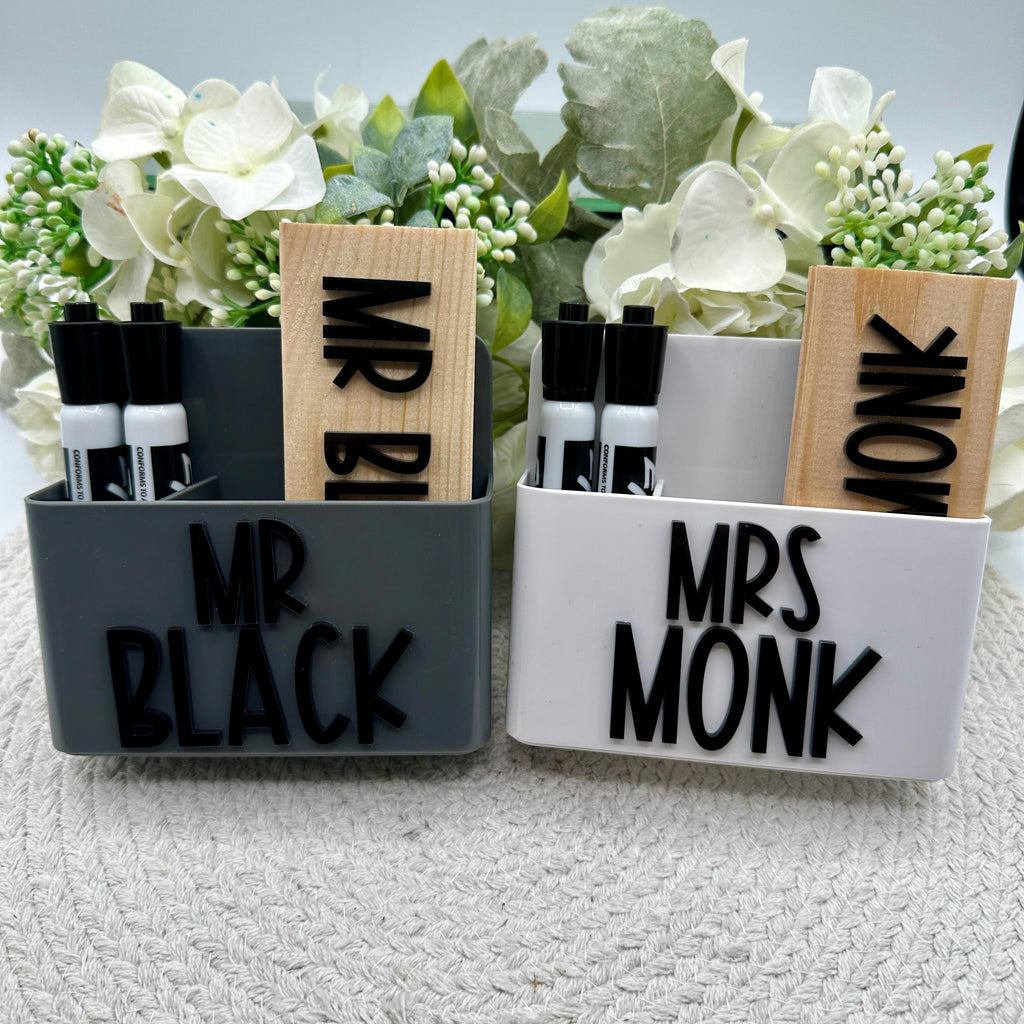 Custom Magnetic Eraser Holder and Eraser Set| Custom Eraser With Expo Markers For Teachers| Gift For Teachers | Back To School Gift |

May include: Two white and gray desk organizers with black lettering. The organizers have a slot for pens and a space for a wooden block with the words &#39;Mr. Black&#39; and &#39;Mrs. Monk&#39; on them.