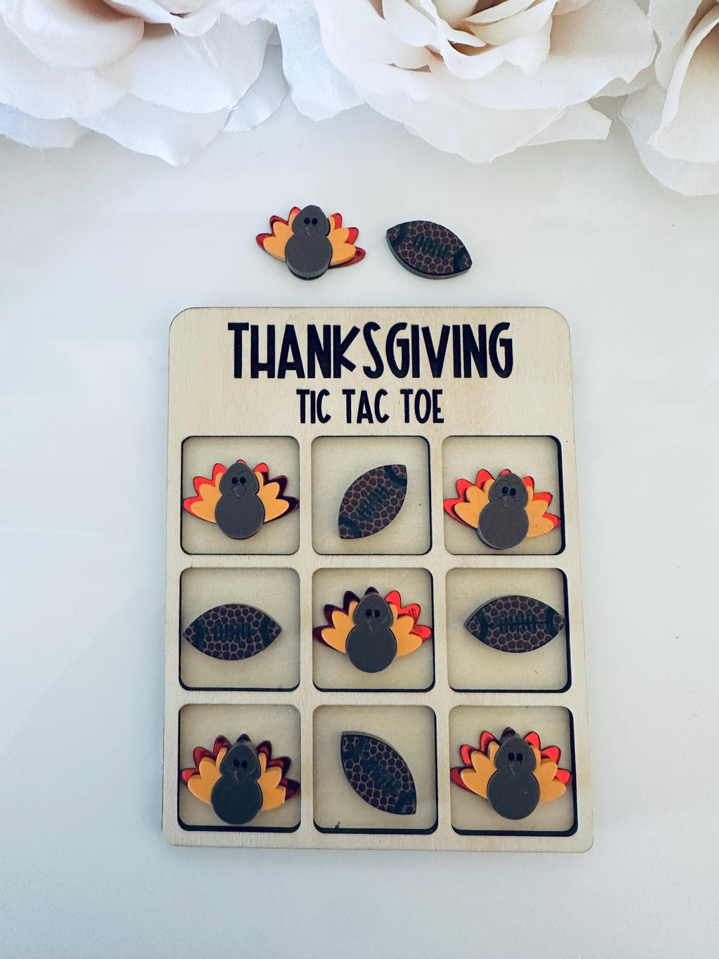Celebrate Thanksgiving with a fun twist! 🦃 This handmade Thanksgiving Tic Tac Toe board features adorable acrylic turkeys and footballs on a solid maple wood base. Perfect for fall family gatherings, classroom fun, or as a festive gift! Each set includes a velvet storage bag for easy cleanup and travel.